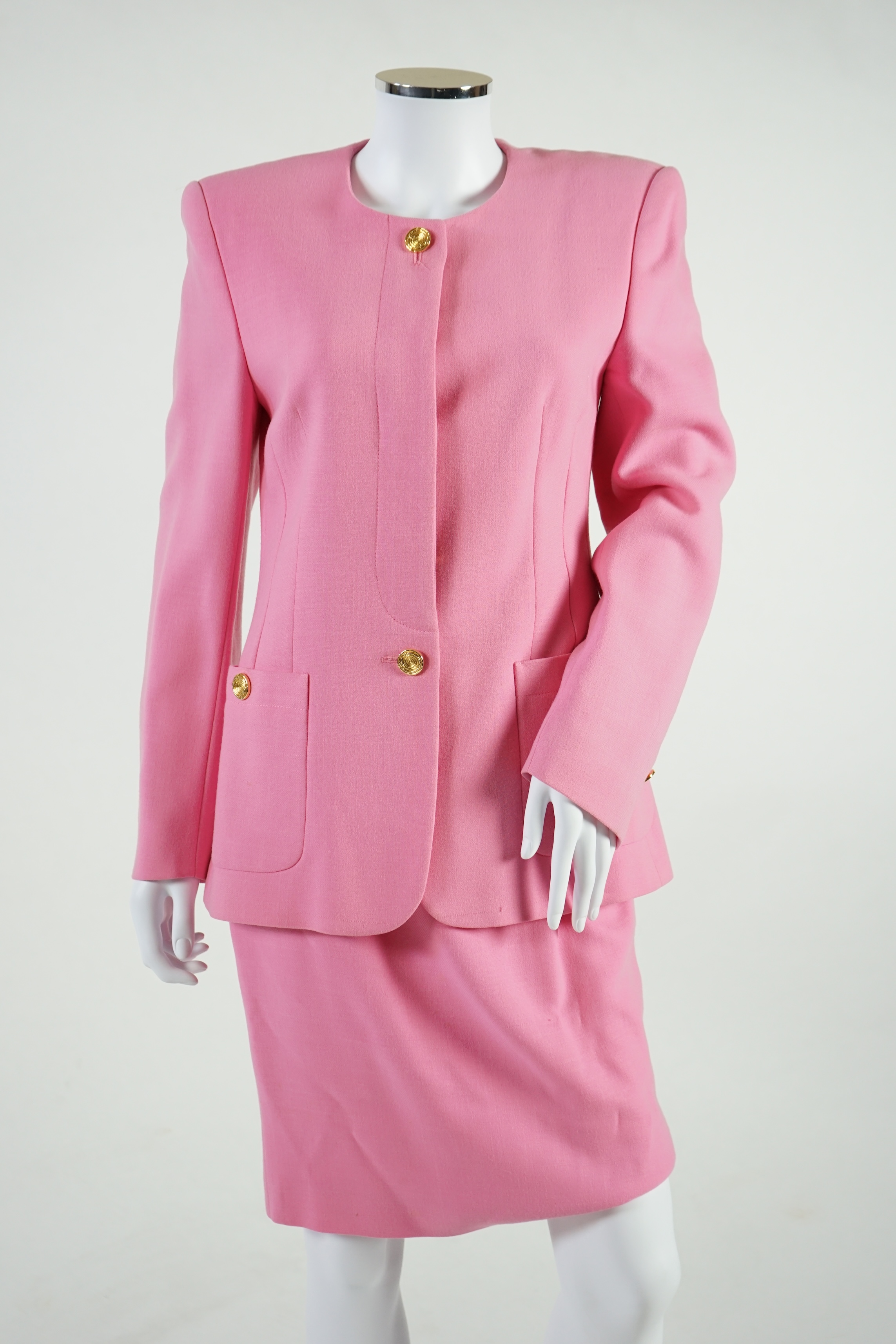 A pink Escada suit with a silk blouse top. Proceeds to Happy Paws Puppy Rescue